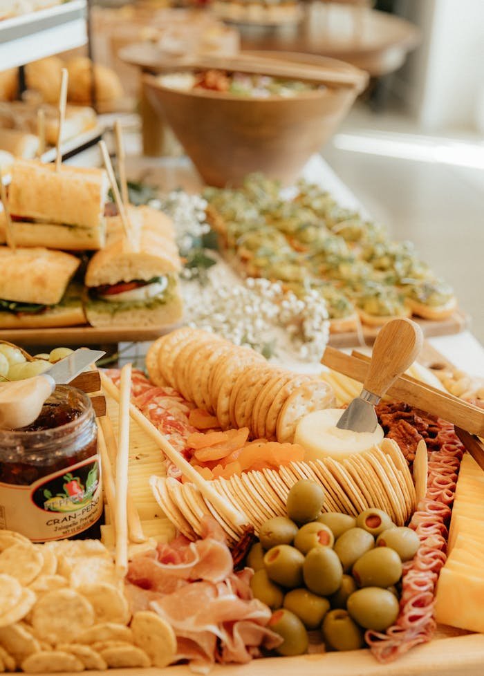 A delicious spread of assorted sandwiches, olives, and crackers creating a perfect party display.