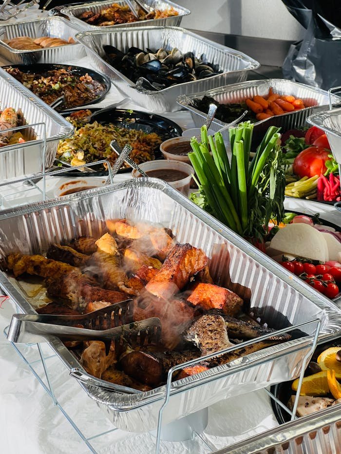 A spread of diverse and delicious dishes at a catered buffet showcasing a variety of cuisines.