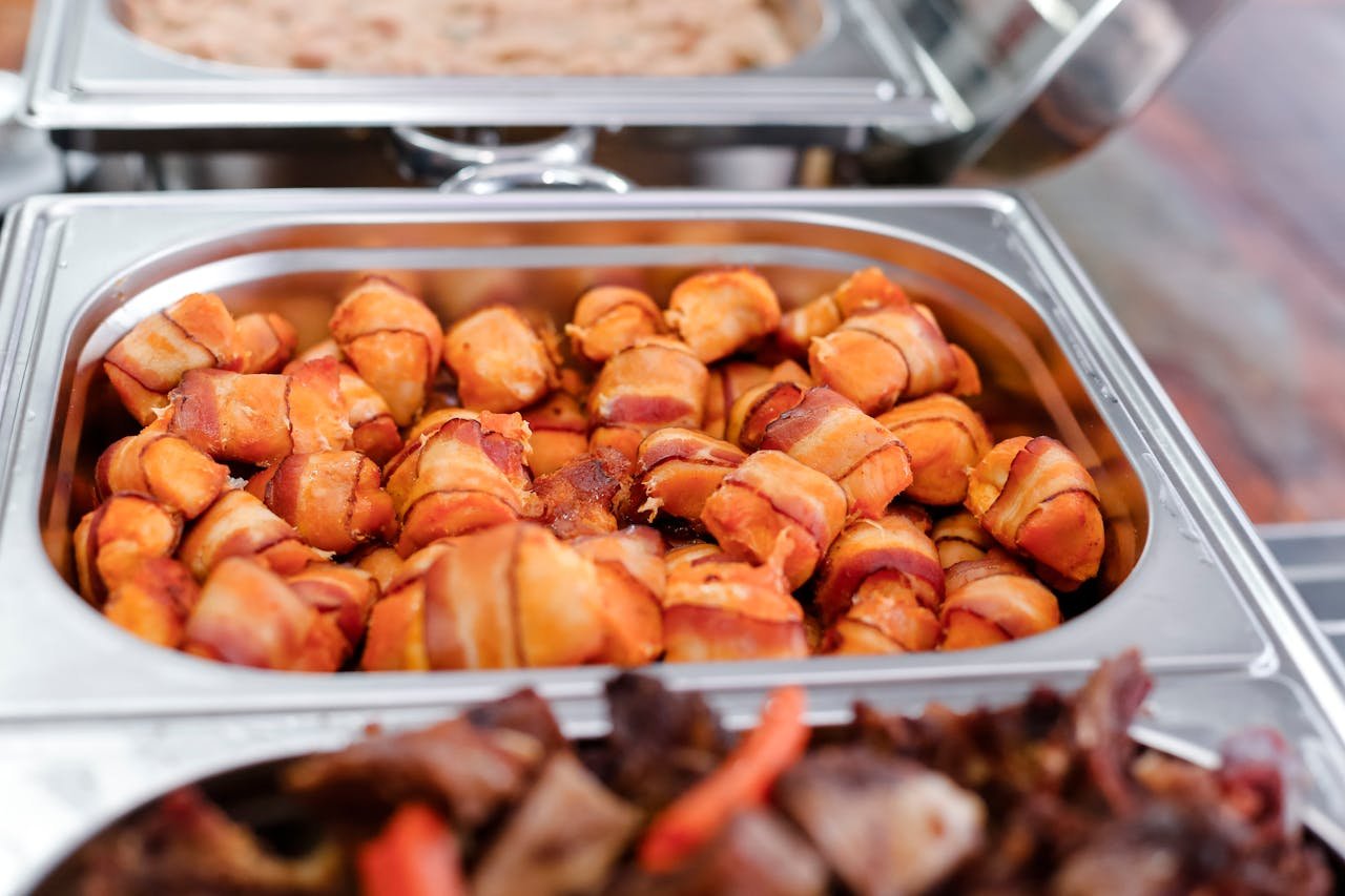 creative-03 Delicious bacon wrapped appetizers ready to serve in a catering tray. Perfect for events.
